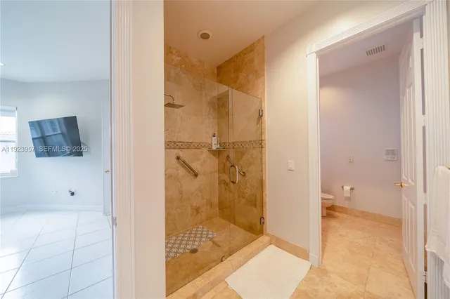 a white toilet sitting next to a bathroom sink