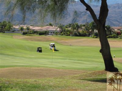 304 Loch Lomond Road Rancho Mirage, CA 92270 - Photo 15 of 17 a view of a lake with a yard