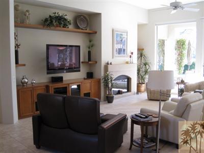 304 Loch Lomond Road Rancho Mirage, CA 92270 - Photo 3 of 17 a living room with furniture a fireplace and a flat screen tv