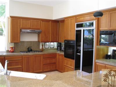 304 Loch Lomond Road Rancho Mirage, CA 92270 - Photo 7 of 17 a kitchen with stainless steel appliances granite countertop a refrigerator and a sink