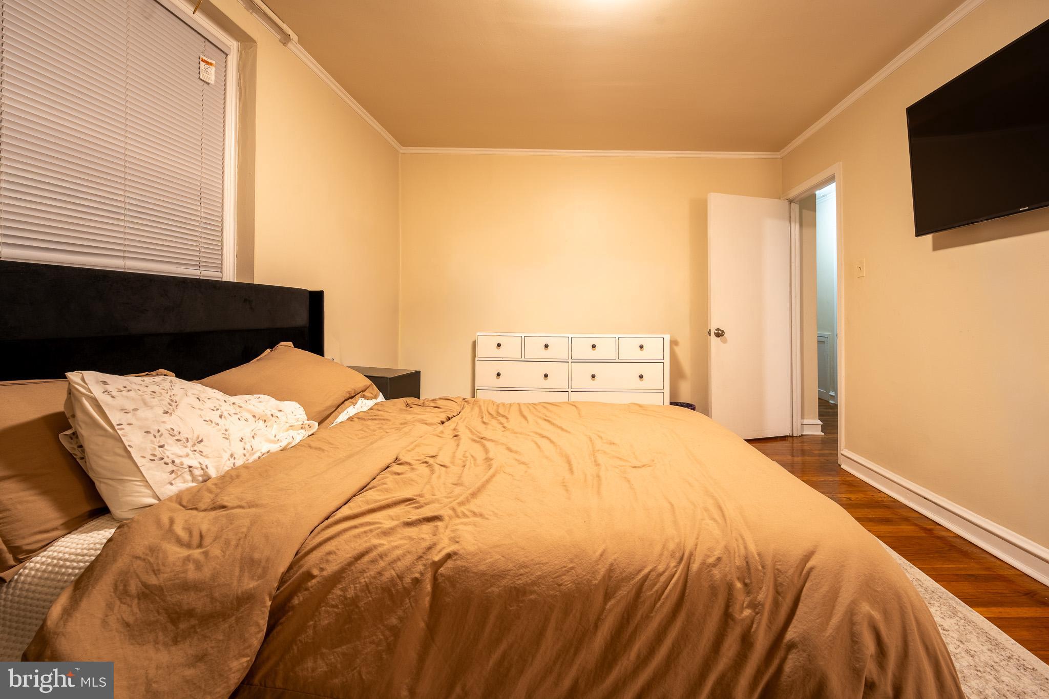 8207 Williams Avenue Philadelphia, PA 19150 - Photo 11 of 21 a bed sitting in a bedroom and a flat screen tv