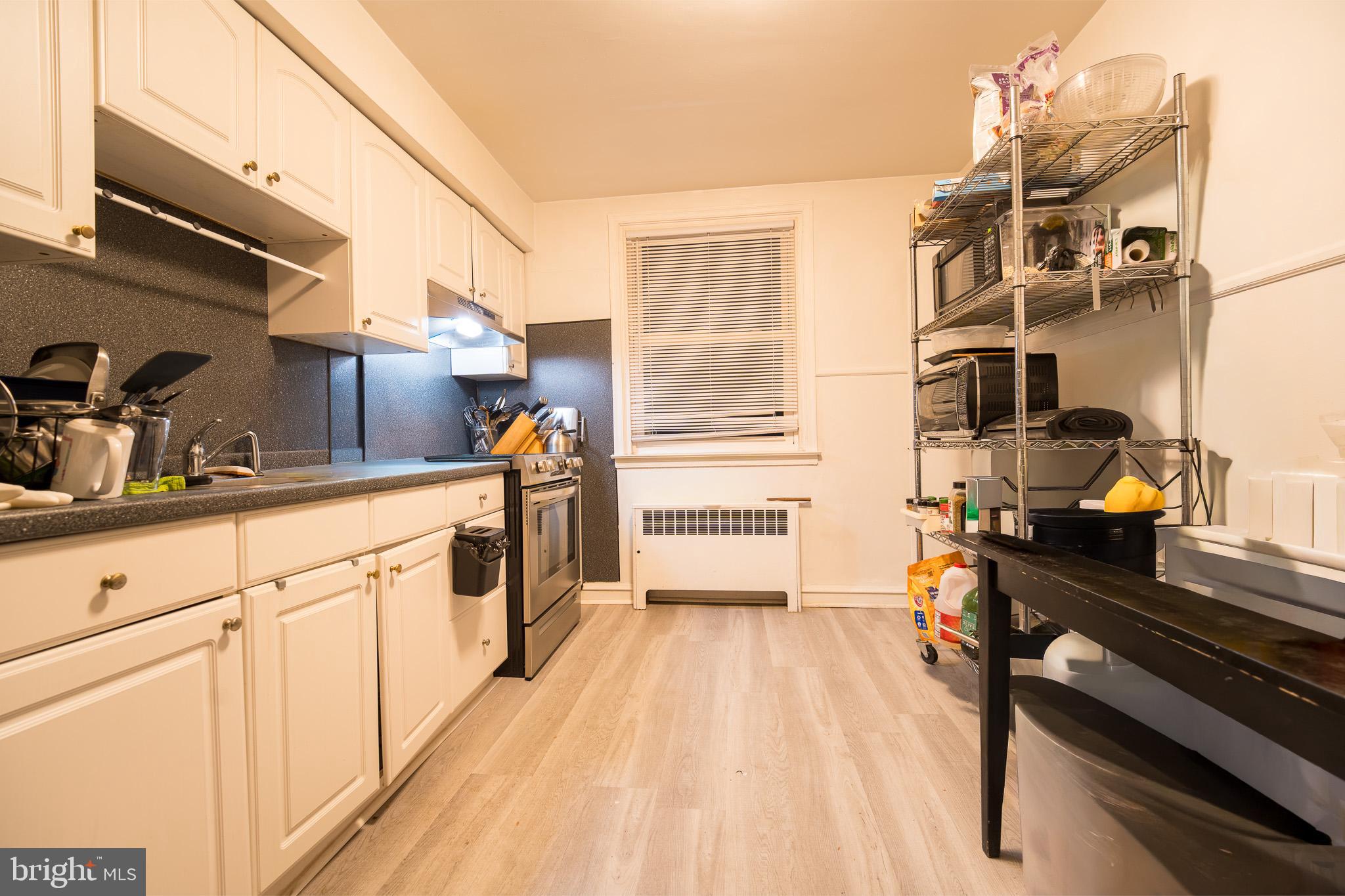 8207 Williams Avenue Philadelphia, PA 19150 - Photo 15 of 21 a kitchen with cabinets a sink and appliances