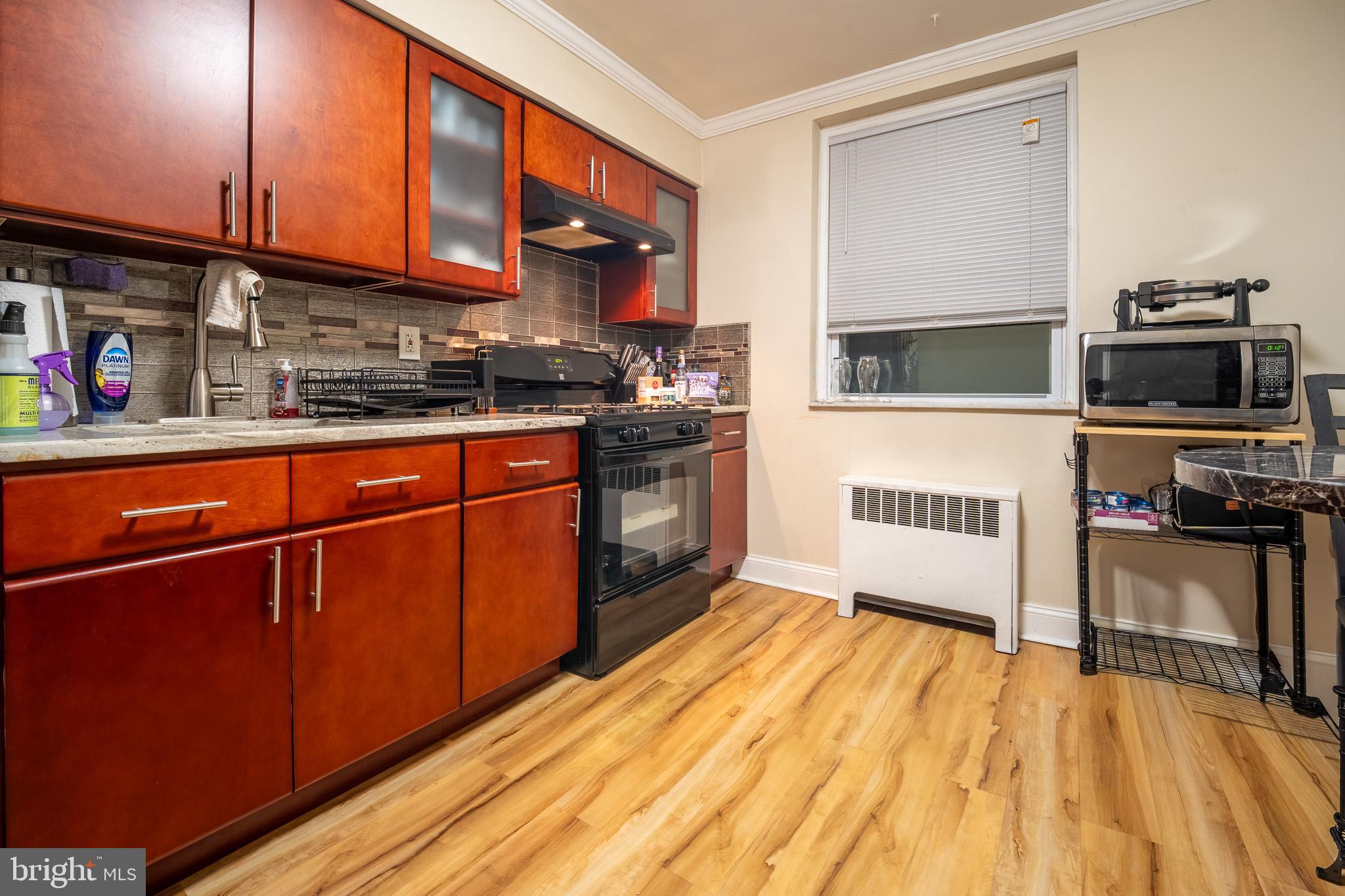 8207 Williams Avenue Philadelphia, PA 19150 - Photo 4 of 21 a kitchen with stainless steel appliances granite countertop a stove a sink and a microwave