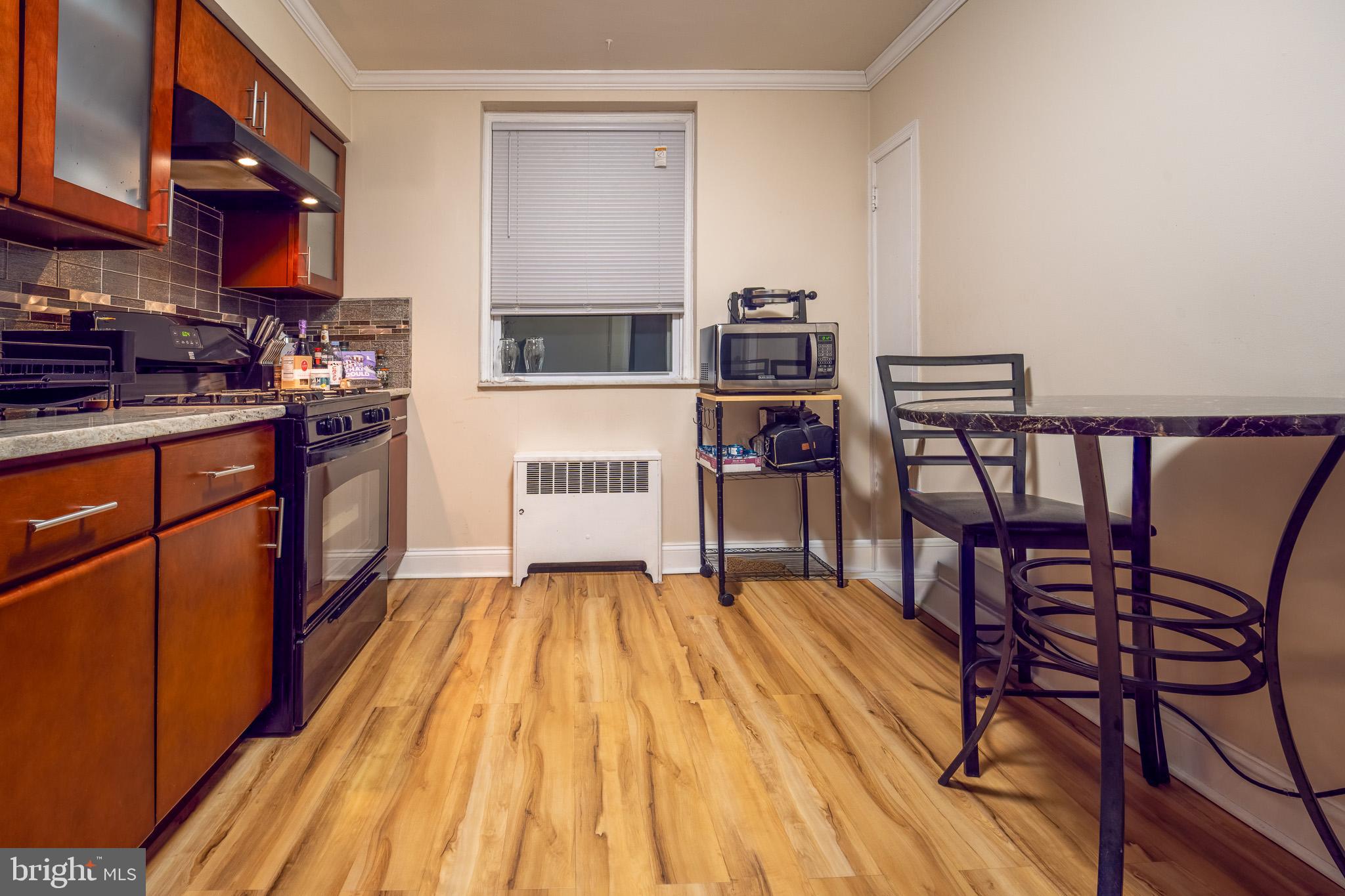 8207 Williams Avenue Philadelphia, PA 19150 - Photo 6 of 21 a living room with stainless steel appliances furniture a rug and a kitchen view