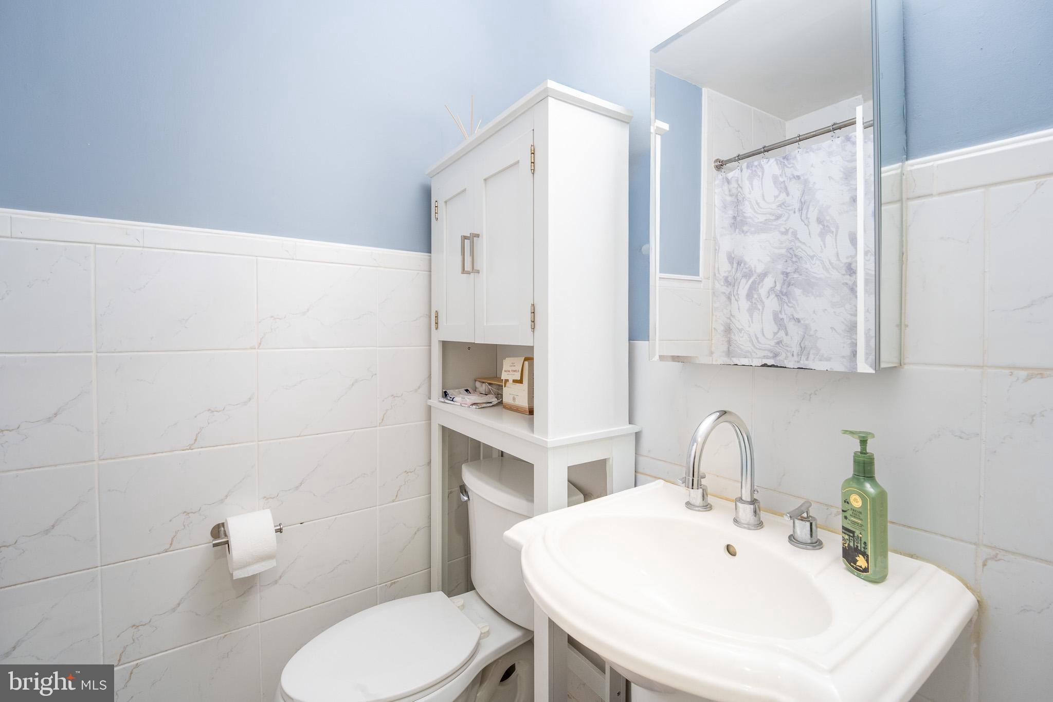 8207 Williams Avenue Philadelphia, PA 19150 - Photo 8 of 21 a bathroom with a sink a toilet and mirror