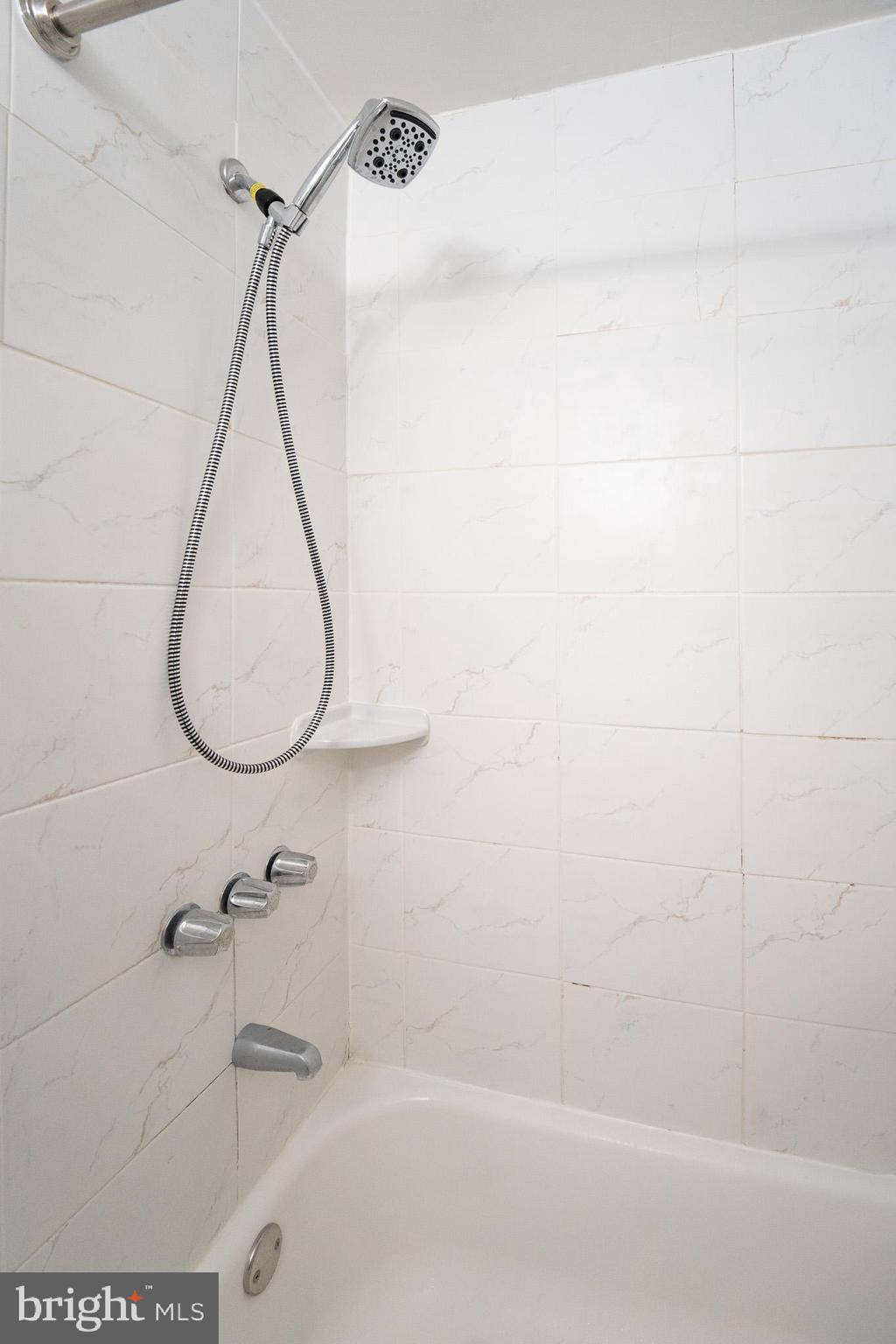 8207 Williams Avenue Philadelphia, PA 19150 - Photo 9 of 21 a bathroom with a bath tub a sink and a shower