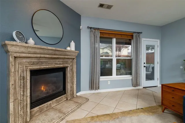 a view of an empty room with a fireplace and a window