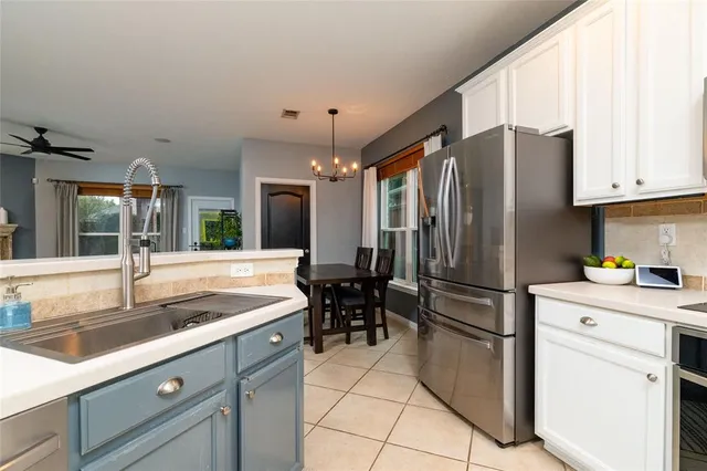 a kitchen with a refrigerator a sink and cabinets