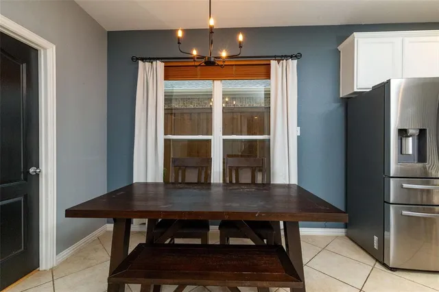 a dining room with a table chairs and refrigerator