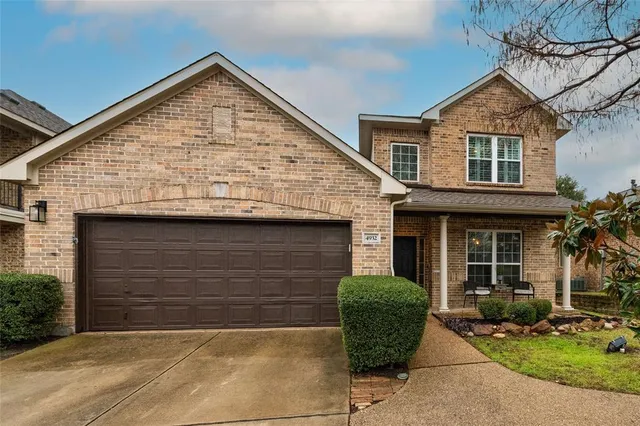 a view of brick house with large windows