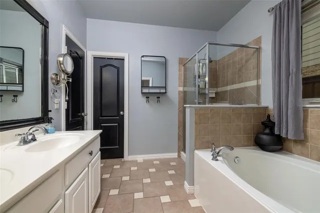 a bathroom with a tub sink and mirror