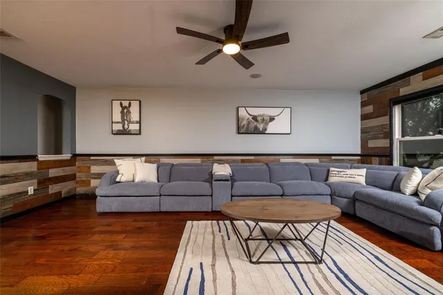 a living room with furniture and a wooden floor