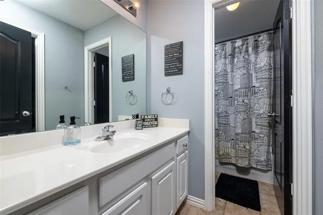 a bathroom with a sink a double vanity and a mirror