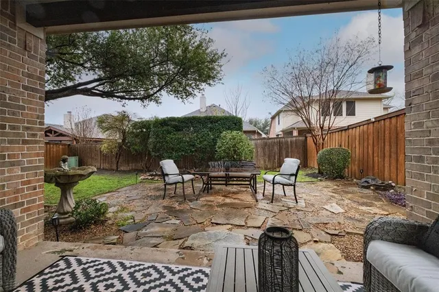 a view of a patio with a table chairs and a fire pit
