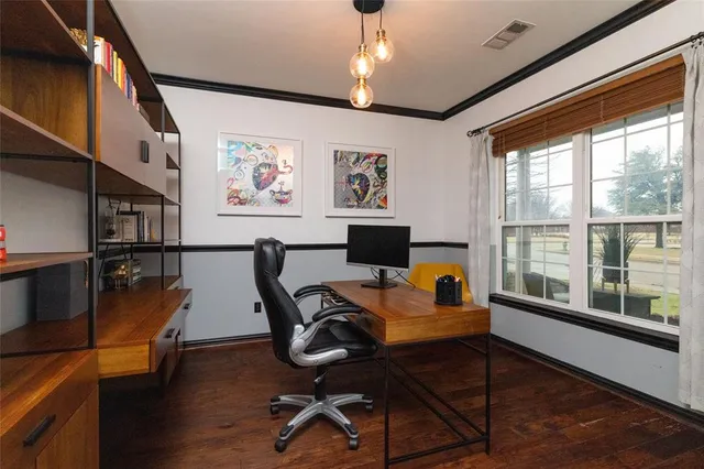 a view of a workspace with furniture a window and a chandelier