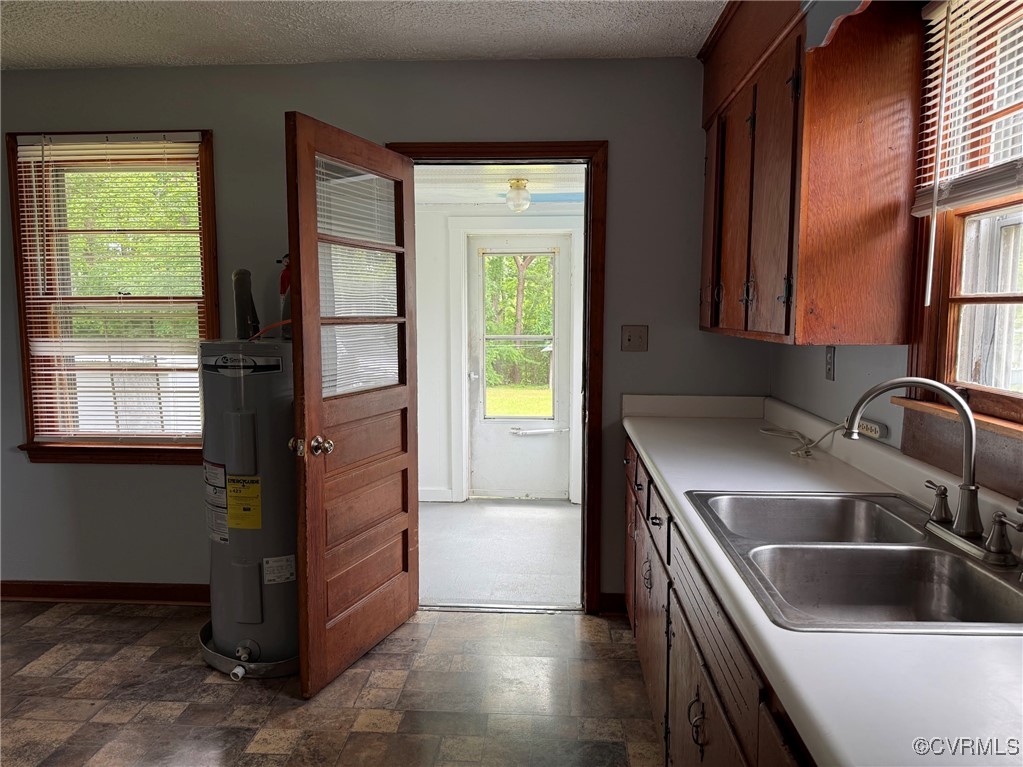 1252 Columbia Road Columbia, VA 23038 - Photo 17 of 41 Kitchen with electric water heater, a sink, stone