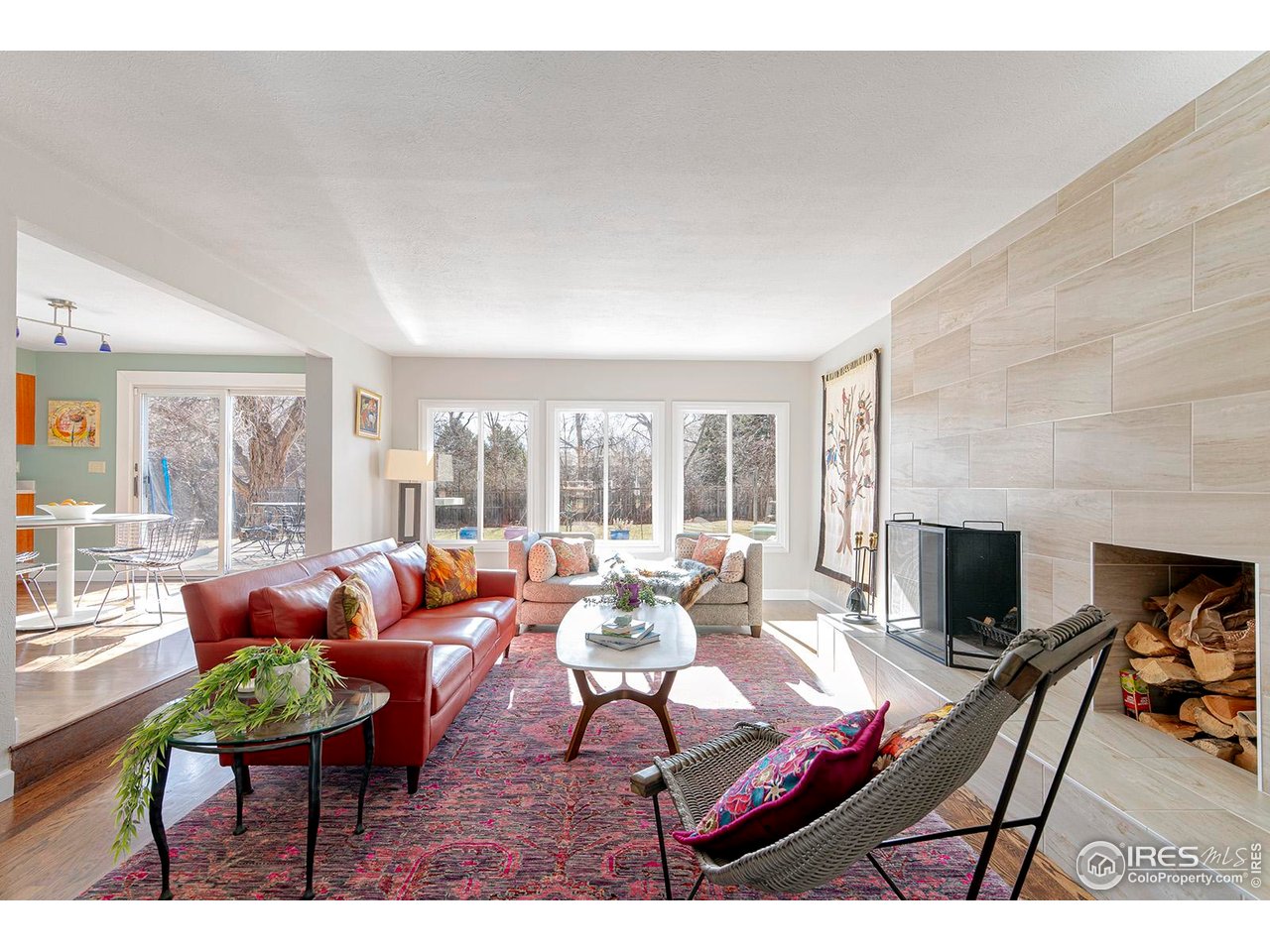 4556 Apple Way Boulder, CO 80301 - Photo 2 of 50 Light filled home with walls of windows facing south to the private back yard. Spacious and cozy living area with wood burning fireplace and stone hearth with seating bench