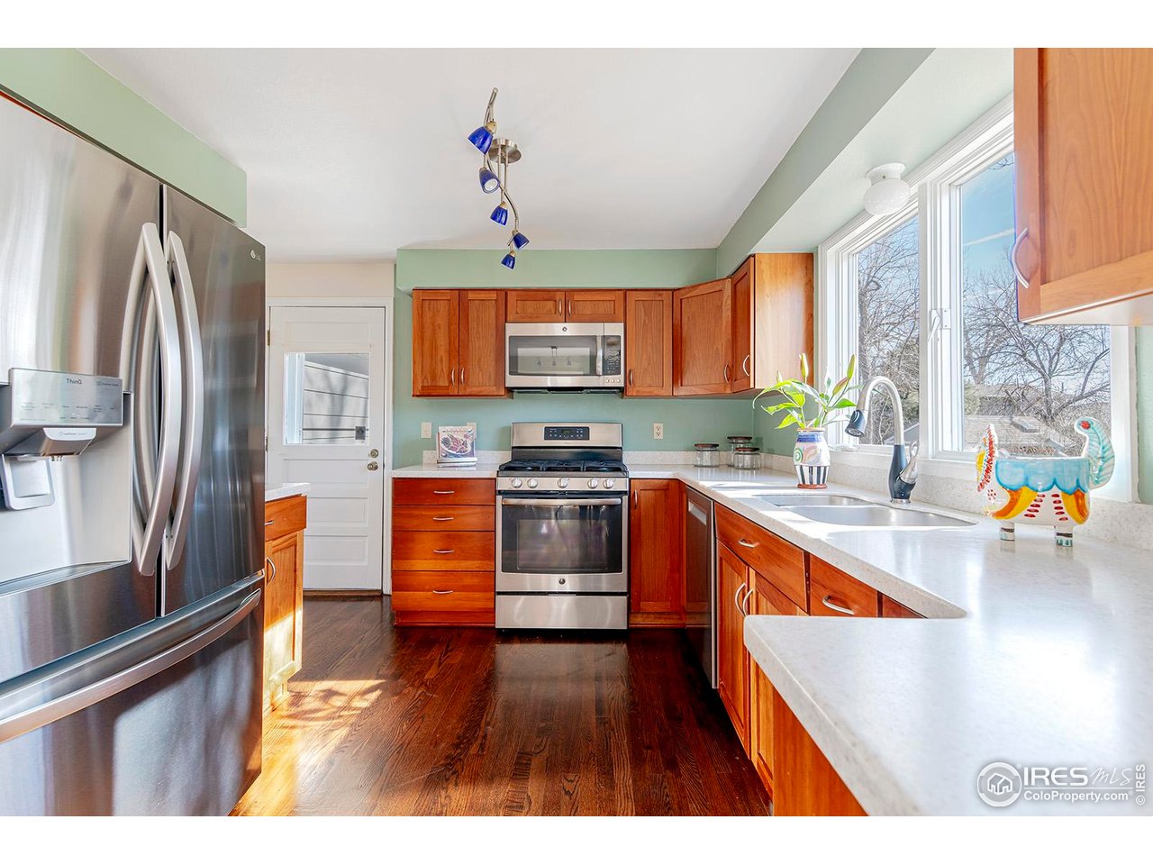 4556 Apple Way Boulder, CO 80301 - Photo 21 of 50 The proverbial kitchen sink overlooking the back deck and yard with new refrigerator