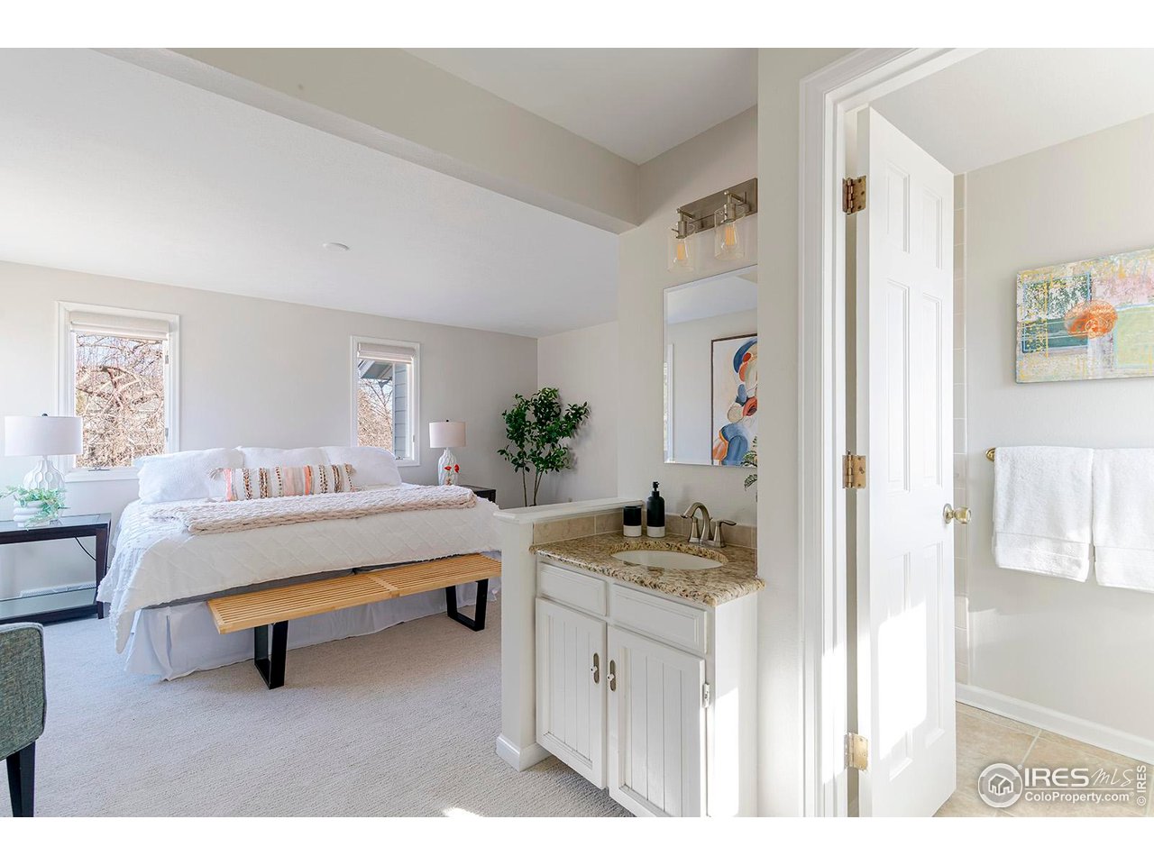 4556 Apple Way Boulder, CO 80301 - Photo 31 of 50 Primary suite with vanity and dedicated shower and toilet room, bathed in southern light.