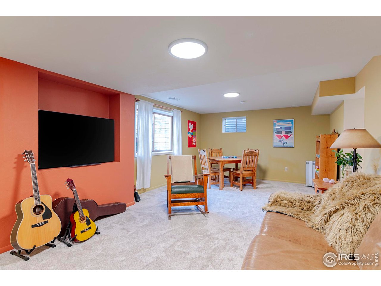 4556 Apple Way Boulder, CO 80301 - Photo 38 of 50 Basement recreation space was painted and carpeted in 2025. Large egress window and lots of space. The other finished space in the basement not pictured. It was also painted and carpeted and can be used as hobby room or for storage