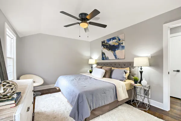 a bedroom with a bed and a chandelier