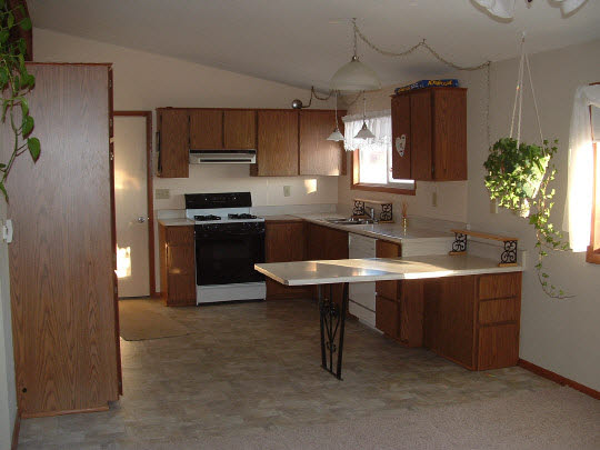 3311 Krupke Road Caledonia, IL 61011 - Photo 2 of 9 a kitchen with kitchen island a sink stove and refrigerator