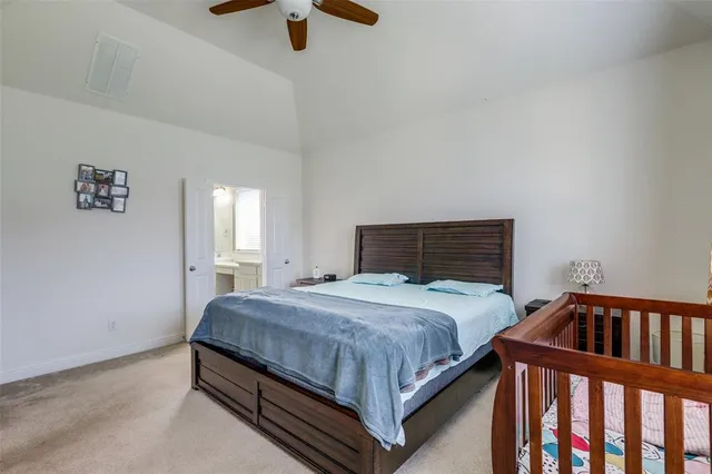 a bed sitting in a bedroom next to a window