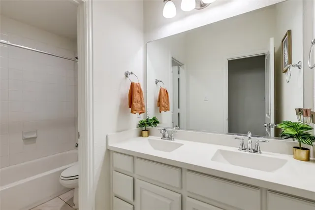 a bathroom with a shower sink and mirror