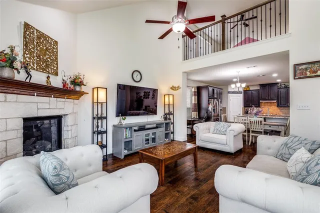 a living room with fireplace furniture and a flat screen tv