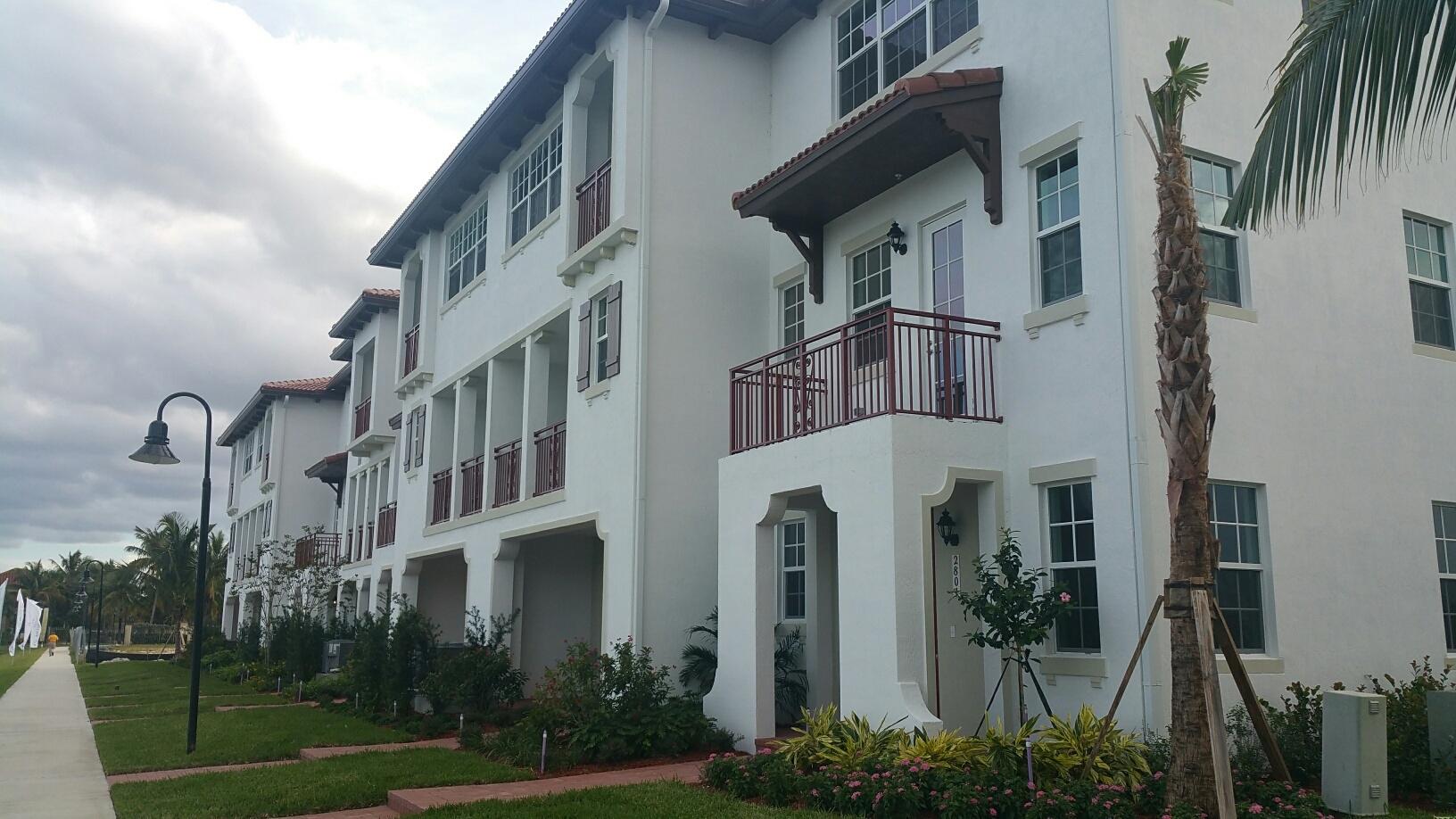 a view of a building with a yard and plants