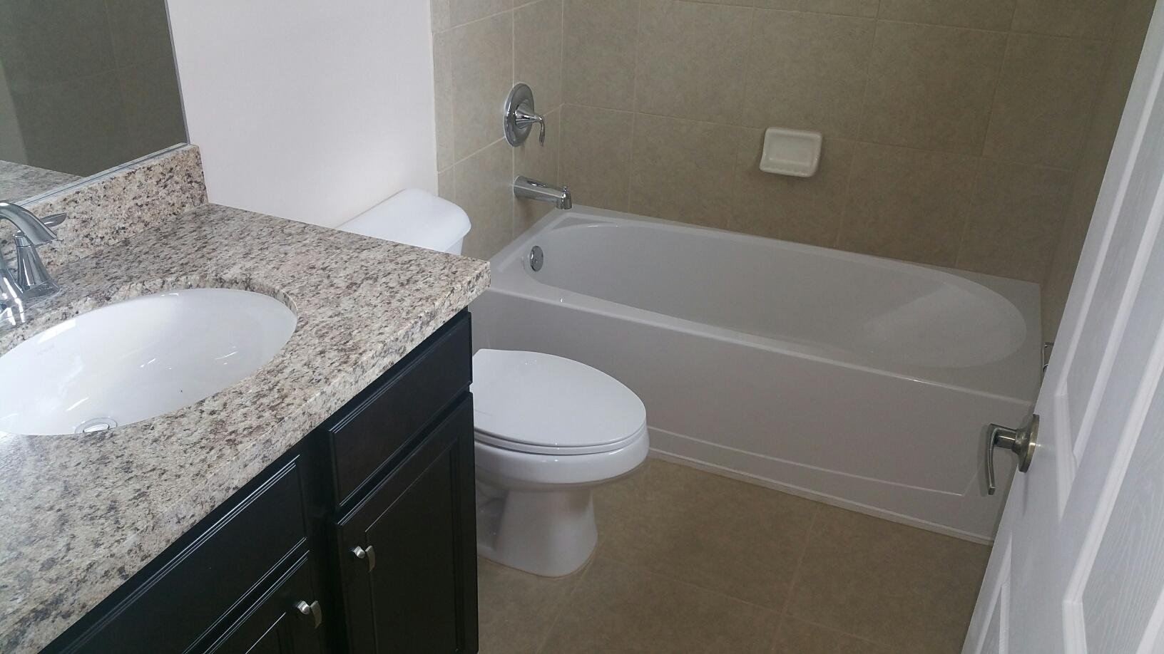 2825 Southwest 119th Way Miramar, FL 33025 - Photo 13 of 23 a bathroom with a granite countertop sink toilet and bathtub