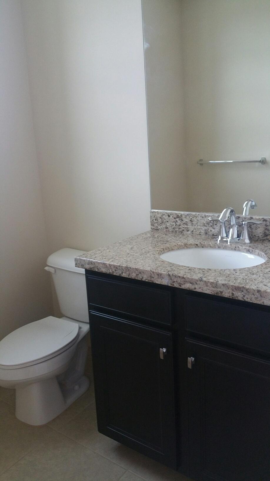 2825 Southwest 119th Way Miramar, FL 33025 - Photo 14 of 23 a bathroom with a granite countertop toilet and a sink