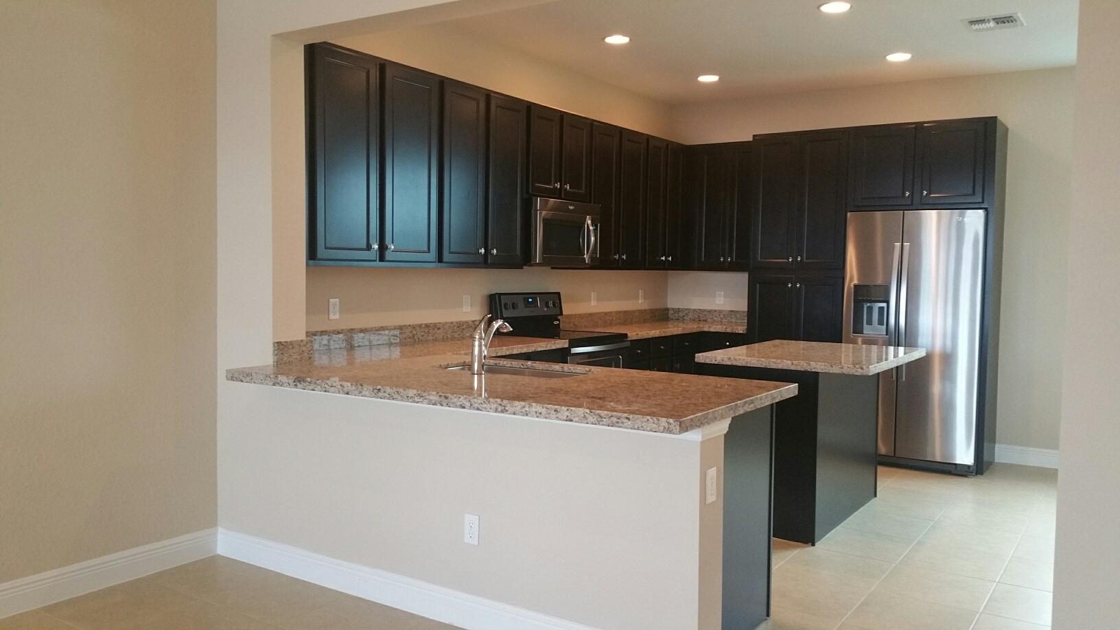 2825 Southwest 119th Way Miramar, FL 33025 - Photo 4 of 23 a kitchen with a sink and a refrigerator