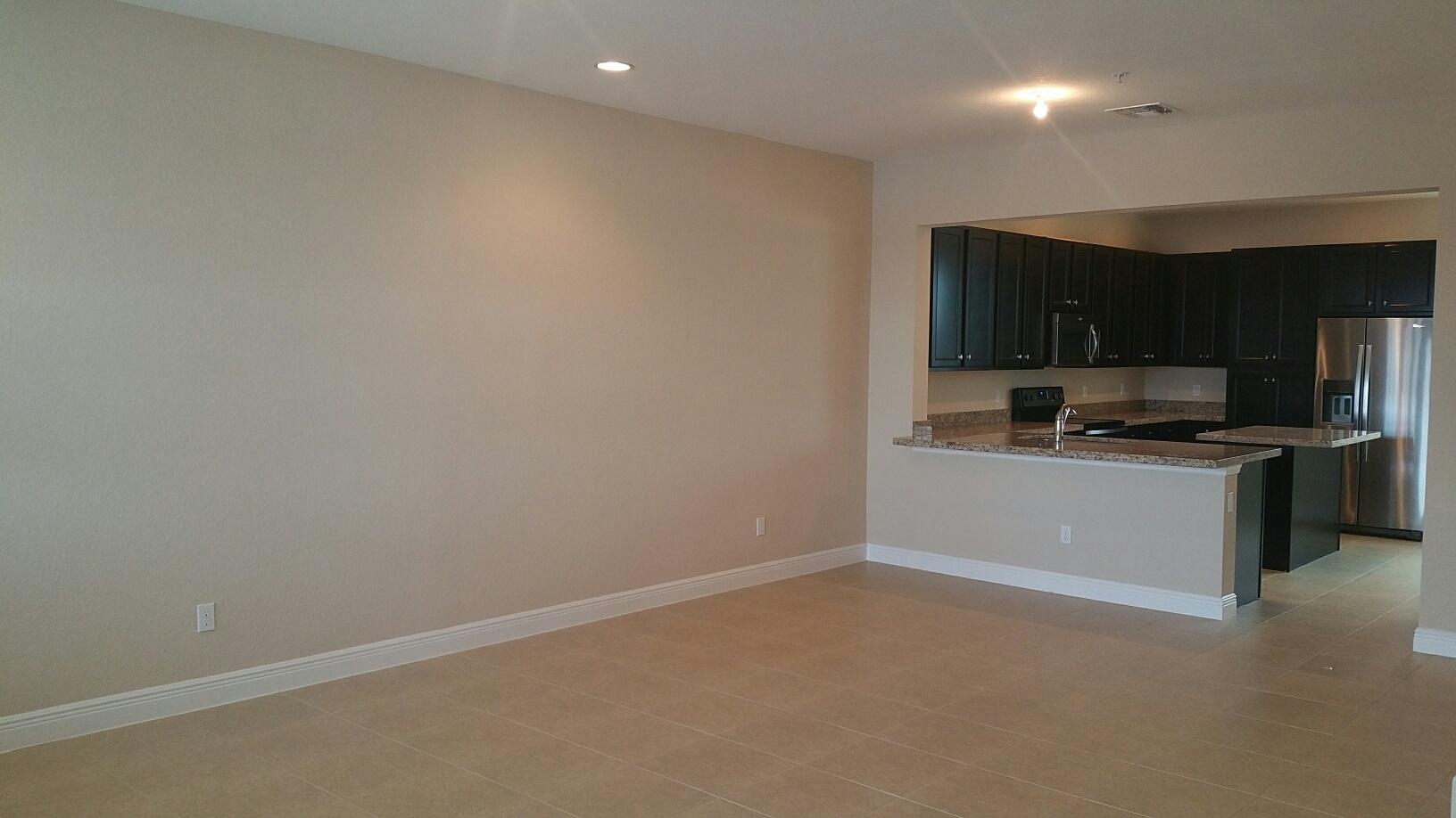 2825 Southwest 119th Way Miramar, FL 33025 - Photo 6 of 23 a kitchen with a refrigerator and a stove top oven