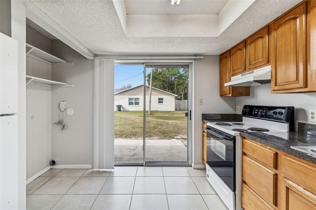 6024 Norton Road Lakeland, FL 33809 - Photo 25 of 56 a kitchen with a refrigerator a stove top oven cabinetry and a sink