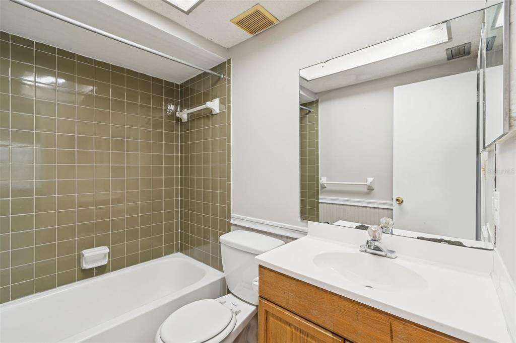 6024 Norton Road Lakeland, FL 33809 - Photo 34 of 56 a bathroom with a sink a toilet a mirror and shower