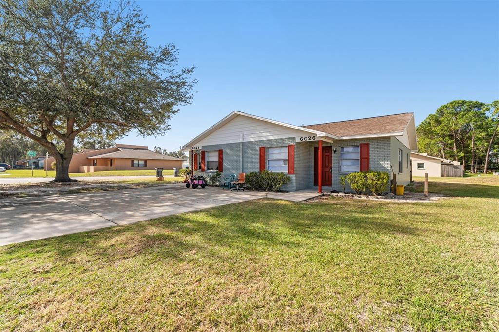 6024 Norton Road Lakeland, FL 33809 - Photo 7 of 56 a front view of a house with swimming pool and green space