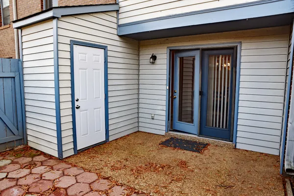 a view of a house with white door and a garage