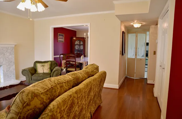 a living room with furniture and a wooden floor