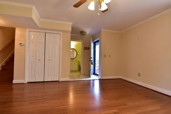 a view of an empty room with wooden floor