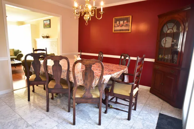 a view of a dining room with furniture and chandelier