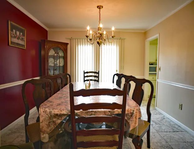 a view of a dining room with furniture and chandelier