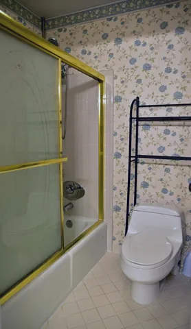 a bathroom with a toilet and a shower