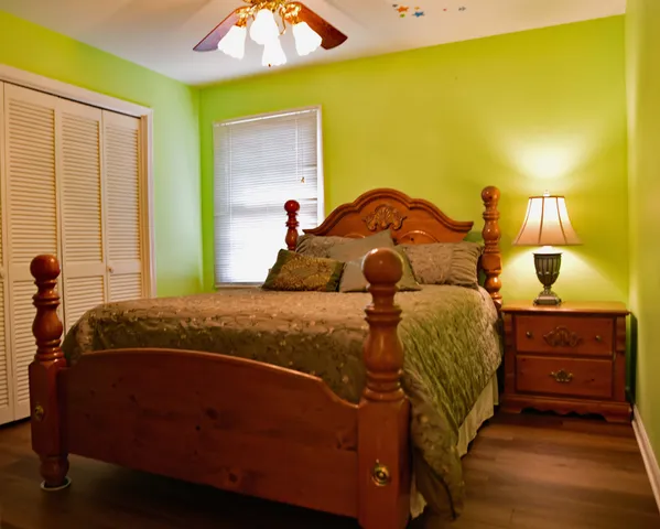 a bedroom with a bed and a window