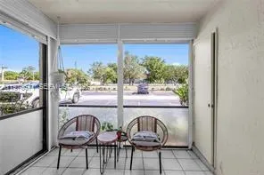 a dining room with furniture a rug and wooden floor