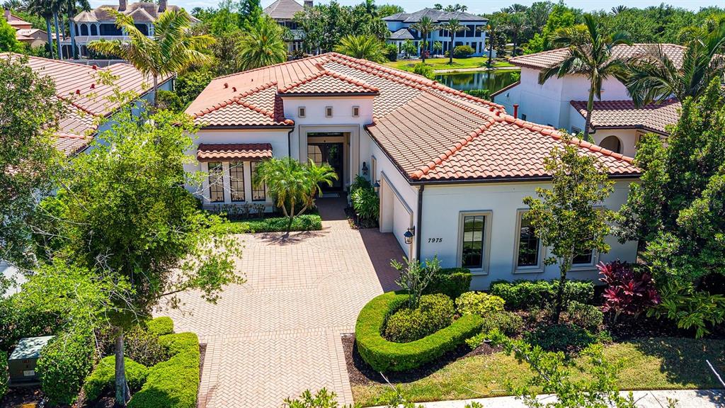 7975 Matera Court Lakewood Ranch, FL 34202 - Photo 1 of 83 a front view of a house with a garden