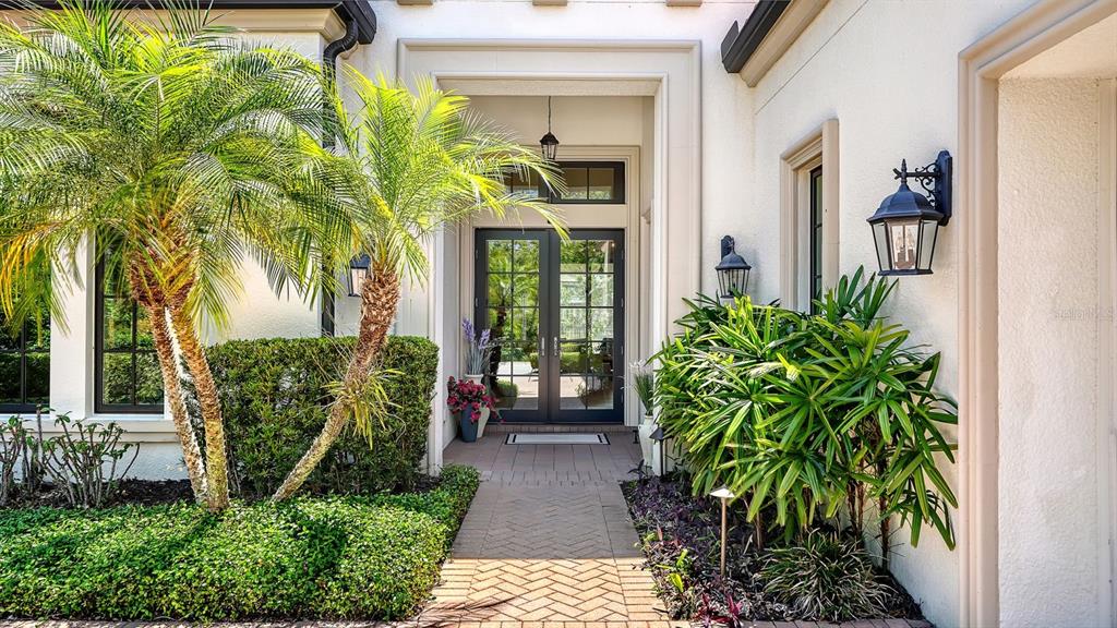 7975 Matera Court Lakewood Ranch, FL 34202 - Photo 13 of 83 a front view of a house with garden