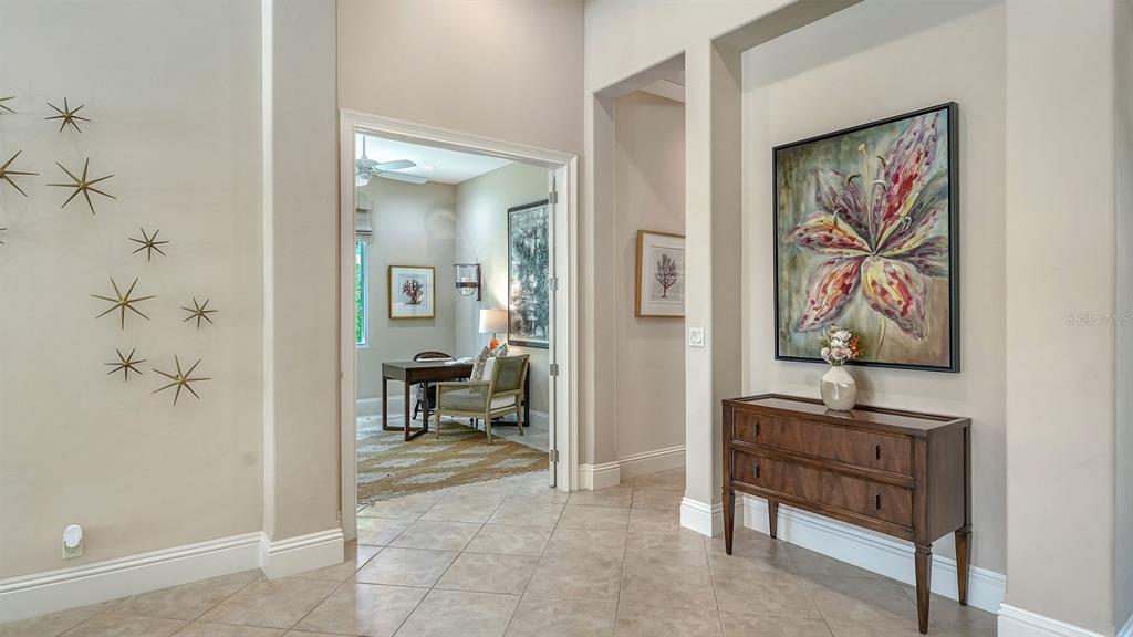 7975 Matera Court Lakewood Ranch, FL 34202 - Photo 15 of 83 a view of a hallway with paintings on the wall