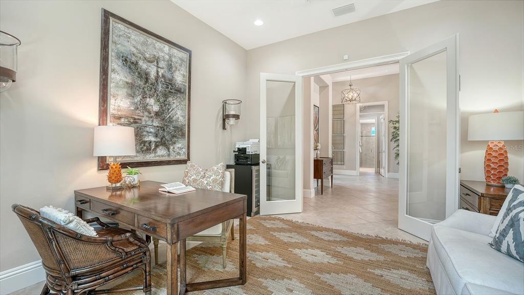 7975 Matera Court Lakewood Ranch, FL 34202 - Photo 17 of 83 a view of a dining room with furniture and a window