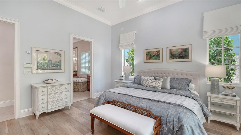 7975 Matera Court Lakewood Ranch, FL 34202 - Photo 29 of 83 a bedroom with a bed and a dresser